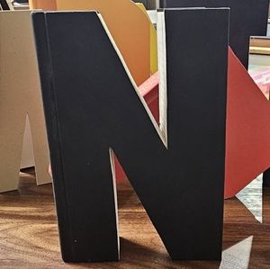 A black letter N, upcycled from a book.
